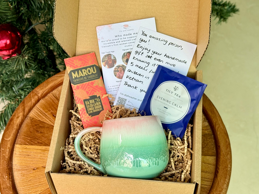 gift set with handmade mug, tea bags, ethical chocolate, and handwritten notes