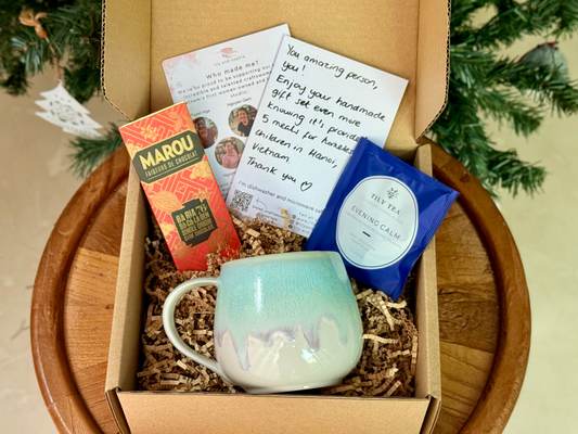 ethical gift box with handmade mug, tea, fair trade chocolate and handwritten gift note